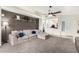 Bright living room with cozy sectional sofa and wood accent wall at 15348 W Banff Ln, Surprise, AZ 85379