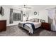 Spacious main bedroom with a king-size bed and ceiling fan at 15348 W Banff Ln, Surprise, AZ 85379
