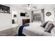 Main bedroom with king bed, attached bathroom, and ceiling fan at 15348 W Banff Ln, Surprise, AZ 85379