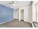 Blue-walled bedroom with a closet and window seat at 17198 W Fetlock Trl, Surprise, AZ 85387