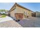 Home's exterior with garage and brick detailing at 17198 W Fetlock Trl, Surprise, AZ 85387