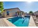 Inviting backyard oasis with a sparkling pool and spa at 17198 W Fetlock Trl, Surprise, AZ 85387