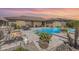 Gorgeous backyard with a pool, spa, and fire pit at sunset at 18111 W Desert Sage Dr, Goodyear, AZ 85338
