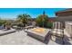 Relaxing patio with fire pit, comfortable seating, and beautiful landscaping at 18111 W Desert Sage Dr, Goodyear, AZ 85338
