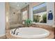 Spa-like bathroom featuring a large soaking tub and walk-in shower at 18111 W Desert Sage Dr, Goodyear, AZ 85338