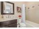 Bathroom with a shower/tub combo, vanity, and decorative art at 18111 W Desert Sage Dr, Goodyear, AZ 85338