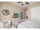 Charming bedroom featuring a comfy bed, built-in shelving, and TV at 18111 W Desert Sage Dr, Goodyear, AZ 85338