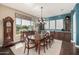 Elegant dining room with a large wood table, chandelier, and built-in cabinetry at 18111 W Desert Sage Dr, Goodyear, AZ 85338