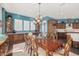 Formal dining room featuring a wood table, chandelier, and access to kitchen at 18111 W Desert Sage Dr, Goodyear, AZ 85338