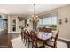 Bright dining room with large windows, a formal dining table, and hardwood floors at 18111 W Desert Sage Dr, Goodyear, AZ 85338
