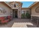 Inviting front entry with stone accents and patio seating at 18111 W Desert Sage Dr, Goodyear, AZ 85338