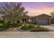 Single-story home with landscaped yard and two-car garage at 18111 W Desert Sage Dr, Goodyear, AZ 85338
