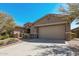Single story home with stone accents and desert landscaping at 18111 W Desert Sage Dr, Goodyear, AZ 85338