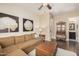 Gathering room with L-shaped sofa, wood floors, and built-in cabinet at 18111 W Desert Sage Dr, Goodyear, AZ 85338