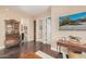 Bright hallway with dark hardwood floors and access to multiple rooms at 18111 W Desert Sage Dr, Goodyear, AZ 85338