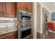 Stainless steel wall oven and microwave combo in a modern kitchen at 18111 W Desert Sage Dr, Goodyear, AZ 85338