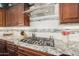 Granite countertop kitchen with stainless steel appliances and custom cabinetry at 18111 W Desert Sage Dr, Goodyear, AZ 85338