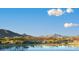 Scenic view of lake, community, and mountain backdrop at 18111 W Desert Sage Dr, Goodyear, AZ 85338