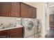 Laundry room with washer, dryer, and ample cabinetry at 18111 W Desert Sage Dr, Goodyear, AZ 85338