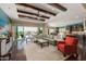 Open living area showcasing hardwood floors, access to backyard oasis, and abundant natural light at 18111 W Desert Sage Dr, Goodyear, AZ 85338