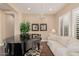 Spacious living room with piano, hardwood floors, and large windows at 18111 W Desert Sage Dr, Goodyear, AZ 85338