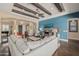 Spacious living room with hardwood floors, exposed beams, and a cozy seating area at 18111 W Desert Sage Dr, Goodyear, AZ 85338