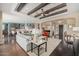 Open concept living room with wood beams and hardwood floors at 18111 W Desert Sage Dr, Goodyear, AZ 85338
