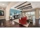 Spacious living room with hardwood floors and a large TV at 18111 W Desert Sage Dr, Goodyear, AZ 85338