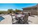 Spacious patio with dining table and chairs, near the pool at 18111 W Desert Sage Dr, Goodyear, AZ 85338