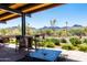 Relaxing patio area with mountain views and water feature at 18111 W Desert Sage Dr, Goodyear, AZ 85338