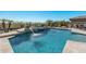 Resort-style pool and spa with a fire pit and outdoor seating area at 18111 W Desert Sage Dr, Goodyear, AZ 85338