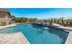 Inviting pool and spa with waterfall features and ample patio space at 18111 W Desert Sage Dr, Goodyear, AZ 85338