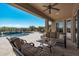 Covered patio overlooks a refreshing pool and spa with mountain views at 18111 W Desert Sage Dr, Goodyear, AZ 85338