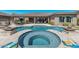 Stunning pool and spa with a built-in fire pit and outdoor kitchen at 18111 W Desert Sage Dr, Goodyear, AZ 85338