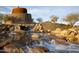 Serene water feature with a stone tower and lush landscaping at 18111 W Desert Sage Dr, Goodyear, AZ 85338