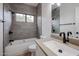Modern bathroom with gray tile, white vanity, and bathtub at 18429 N 16Th Way, Phoenix, AZ 85022