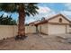 Home exterior featuring a two-car garage and palm tree at 18429 N 16Th Way, Phoenix, AZ 85022