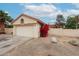 House exterior with two-car garage and flowering vines at 18429 N 16Th Way, Phoenix, AZ 85022