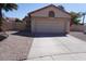 Exterior garage with paved driveway, desert landscaping, tile roof and bougainvillea at 18429 N 16Th Way, Phoenix, AZ 85022
