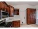 Updated kitchen, featuring dark wood cabinets and pantry at 18429 N 16Th Way, Phoenix, AZ 85022