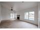 Bright living room features a fireplace, wood-look floors, and sliding doors to a pool at 18429 N 16Th Way, Phoenix, AZ 85022