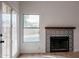 Living room with fireplace, wood-look floors and backyard view at 18429 N 16Th Way, Phoenix, AZ 85022