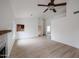 Spacious living room with wood-look floors, fireplace, and ceiling fan at 18429 N 16Th Way, Phoenix, AZ 85022