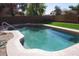 Backyard pool with stone surround and landscaping offers outdoor enjoyment at 18429 N 16Th Way, Phoenix, AZ 85022