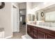 Double vanity bathroom with granite countertops and a view into bedroom at 19000 E Old Beau Trl, Queen Creek, AZ 85142