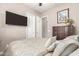 Bright bedroom featuring a large TV and ample storage at 19000 E Old Beau Trl, Queen Creek, AZ 85142