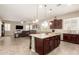 Open kitchen with large island, stainless steel appliances, and views to living area at 19000 E Old Beau Trl, Queen Creek, AZ 85142