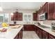 Gourmet kitchen with granite countertops, custom cabinetry, and breakfast bar at 19000 E Old Beau Trl, Queen Creek, AZ 85142