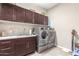 Laundry room with washer, dryer, and cabinets at 19000 E Old Beau Trl, Queen Creek, AZ 85142