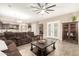 Living room with sectional sofa and view into kitchen at 19000 E Old Beau Trl, Queen Creek, AZ 85142